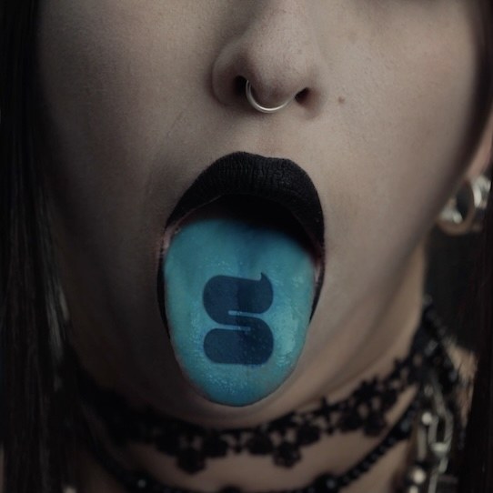 A tongue stained blue from a Slurpee, printed with a large S