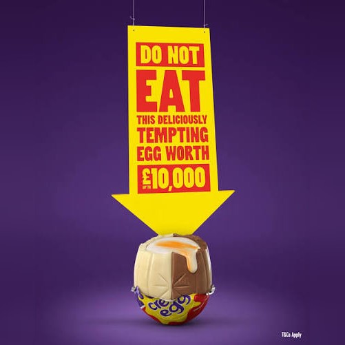 Yellow arrow sign over a Creme Egg: Do not eat this deliciously tempting egg worth up to £10,000