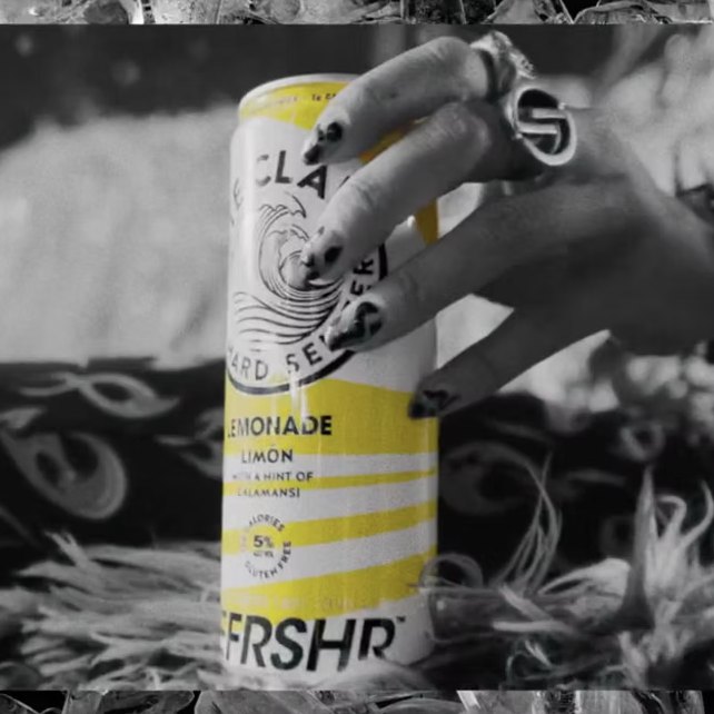Hand with painted nails holding a can of White Claw REFRSHR Lemonade